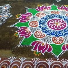 an artistic design on the ground with white and pink flowers painted on it's surface