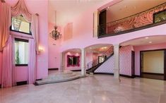 a large foyer with pink walls and marble floors