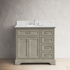 a bathroom vanity with a marble top and two faucets on the sink area