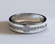 two wedding bands with princess cut diamonds on each side and channel set in the middle