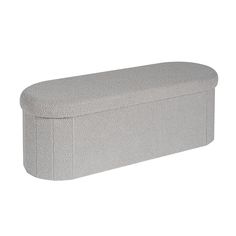 a large gray bench sitting on top of a white floor