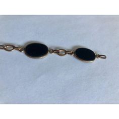 This is part of Chairish’s Fine Jewelry assortment.  This gorgeous 1950s 12K Gold Oval Onyx Link Bracelet has five smooth-sided black onyx stones wrapped in 12K gold and separately by matching chain links. Simply elegant and ready to wear, this link bracelet, which appears to have the Coro mark (illegible), will be a fabulous addition worn alone or stacked with other complementary bracelets for maximum impact.  Dimensions: 7.5" L Condition: Good vintage condition; wear consistent with age. Please see pics for details. Marks: 12KT, Coro(?) Classic Black Link Jewelry, Vintage Onyx Gold Jewelry, Vintage Gold Onyx Jewelry, Black Link Jewelry For Formal Occasions, Elegant Black Link Jewelry, Vintage Gold Bracelet With Polished Finish For Formal Occasions, Timeless Oval Black Enamel Jewelry, Formal Oval Onyx Jewelry, Vintage 14k Gold Oval Link Bracelets