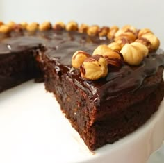 a piece of chocolate cake with nuts on top