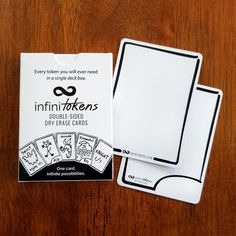 the card game infiniti - tokens is sitting on a wooden table