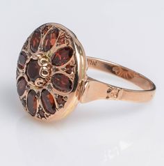 Handmade 14K Rose Gold Ring with Garnet Oval Flower Shape Garnet is a stone of regeneration and energizing it can boost energy. It is said to be stabilizing in that it can bring order to chaos whether internal or external. Details and Measurements: ► 14 Karat Rose Gold ► Size 7.5 (select your size) ► Central Garnet 5 mm ► 8 Garnet stones 5x3 mm ► 8 Garnet stones 1.75 mm ► Total Weight 7.7 gr All items are Handmade, I pay a lot of attention to every piece. All of my items are hand crafted in Kisu Luxury Rose Gold Garnet Jewelry, Yellow Gold Garnet Ring With Rose Cut Diamonds, Victorian 14k Gold Cluster Ring With Gemstone, Oval Ruby Ring In 14k Rose Gold, Heirloom Style Oval Gemstone Flower Ring, Heirloom Oval Gemstone Flower Ring, Heirloom Flower Ring With Oval Gemstone, Heirloom Oval Flower Ring With Gemstone, Formal 14k Rose Gold Ruby Ring