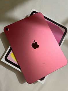 two pink ipads sitting on top of each other