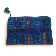 Looking for the perfect ZERO WASTE accessory? Then this little Pouch (and it's slightly smaller, sister Lunita) is what you've been looking for. This darling clutch sized Travel pouch is perfect for keeping your things in order when you travel near and far. Its bold textile print comes from re-purposed traditional hand-woven huipiles, the indigenous clothes of local Maya women. Instead of throwing out these leftover scraps from past projects, we preserve their integrity and give them a second li Travel Wallets With Zipper Pouch, Travel Wallet With Zipper Pouch, Bohemian Zipper Pouch Clutch For Daily Use, Bohemian Cosmetic Bag With Zipper For Everyday Use, Bohemian Style Zipper Cosmetic Bag, Bohemian Clutch With Zipper Pouch For Daily Use, Bohemian Pouch Cosmetic Bag For Travel, Blue Travel Pouch Coin Purse, Blue Bohemian Pouch Clutch