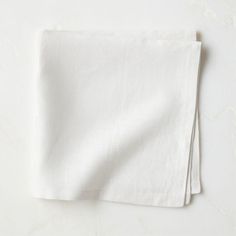 two white linen napkins folded on top of each other