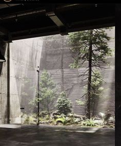 an empty parking garage with trees in the background