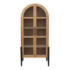 an arched wooden bookcase with glass doors