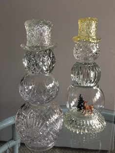 three glass candlesticks are stacked on top of each other