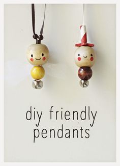 two wooden beads with faces on them are hanging from a string that says diy friendly pendants