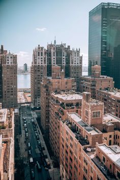 an aerial view of the city with lots of tall buildings and water in the background