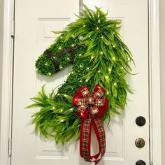 a door decorated with a horse head and christmas lights on it's front door