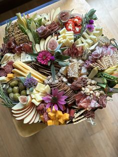 a table topped with lots of different types of cheese and meats on top of it