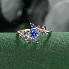 a close up view of a ring with blue stones on the front and back of it