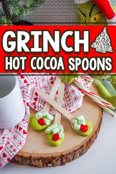 grinch hot cocoa spoons on a wooden board