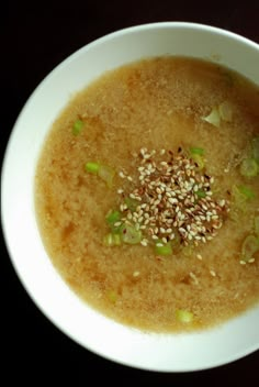 a white bowl filled with soup on top of a table