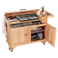 a wooden cabinet with many different types of art supplies in it and two drawers on each side