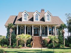 a large house with two stories and lots of windows on the second story, along with steps leading up to the front door