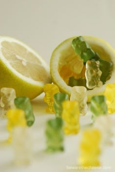 some gummy bears are cut in half and sitting next to a lemon