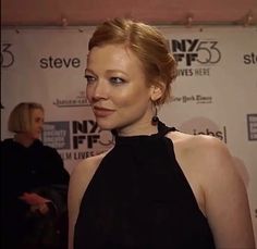 a woman in a black dress at an event