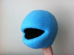 a close up of a blue ball on a wooden stick with a black hole in it