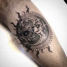 a man with a skull and sun tattoo on his arm