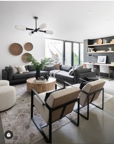 a living room with couches, chairs and tables next to a large open window