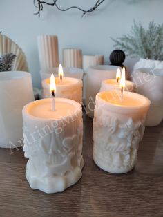 four candles are sitting on a table