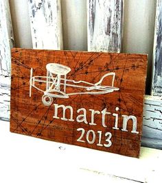 a wooden sign that says martin 2012 on it and an airplane with the name martin 2013