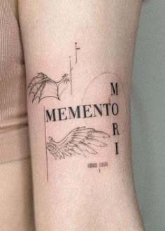 a woman with a tattoo on her arm that says, mementoo r i