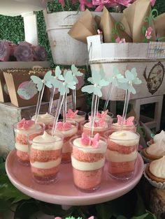 some cupcakes are sitting on a pink plate