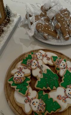 cookies decorated with frosting and sprinkles on a wooden platter