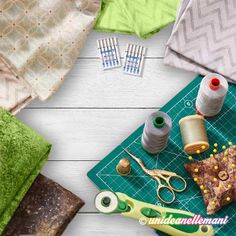 sewing supplies laid out on a cutting board with scissors, thread, and other items