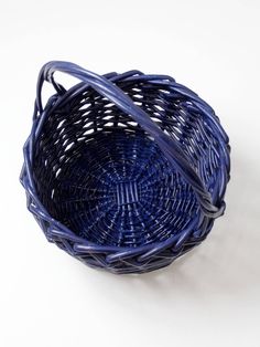 a blue basket sitting on top of a white table