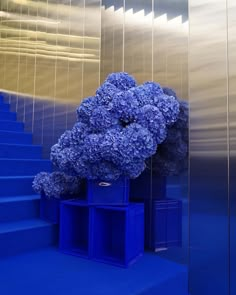 a blue vase sitting on top of a set of stairs