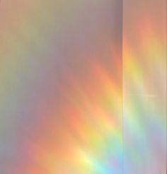 an image of the back side of a wall with rainbow colored light coming from it