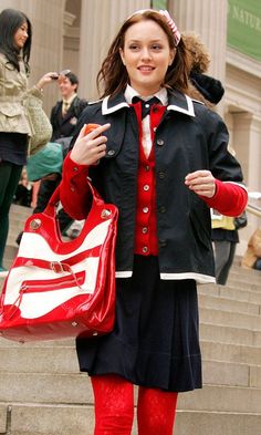 a woman in red tights and black jacket carrying a white handbag on steps