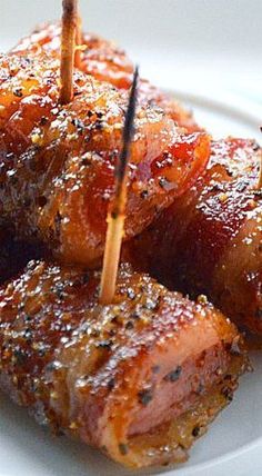 several pieces of meat with toothpicks sticking out of them on a white plate