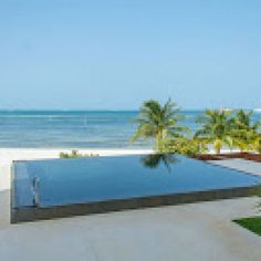 an empty swimming pool next to the ocean