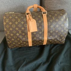 Louis Vuitton Keepall Bandouliere Shoulder Bag 45 Brown Leather. In New like condition. Great bag for travel or a little extra personality. Strap can not be added. Price is firm. This is not a resale item, it is my personal item and price is non-negotiable. Thank You for your consideration. Blessings High-end Tan Travel Bags, Louis Vuitton Keepall 25, Travel Bag In Monogram Canvas With Original Box, Designer Tan Travel Bag, Designer Brown Bag For Trips, Designer Brown Duffle Bag With Large Capacity, Designer Brown Luggage For Daily Use, Large Capacity Monogram Canvas Travel Bag, Designer Bags With Luggage Sleeve For Trip