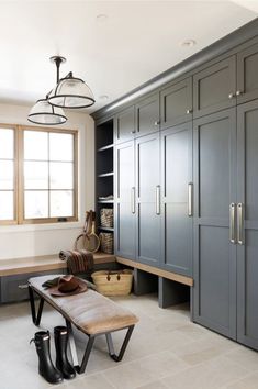 a kitchen with gray cabinets and a bench