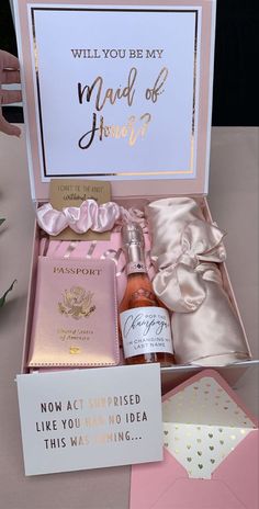 a pink box with some wine and other items in it that says, will you be my maid of honor?