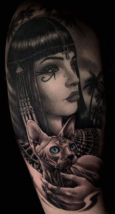 a woman with blue eyes holding a cat tattoo on her left upper arm and shoulder