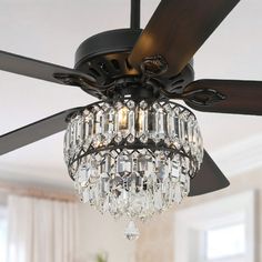 a ceiling fan with crystal chandelier hanging from it