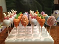 there are many different types of candy on the stick together in this display case, including cake pops