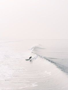 a person riding a wave on top of a surfboard