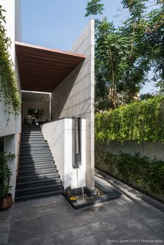 stairs leading up to the top floor of a modern house with concrete walls and steps