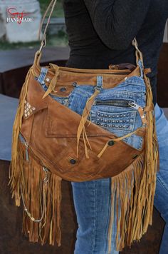 Model Name:  ----| "Light Brown Fringes" I have handcrafted this unique one of a kind shoulder bag with high-quality new & recycled selected materials. Every detail I did on the bag has a role in the whole design. Every stitch I made has a meaning. / Features: ----| Adjustable leather shoulder strap with buckle. ----| The inner lining is made of cotton-polyester with print + denim + leather. ----| Zip closure. ----| Inner pockets: 4; Outer pockets: 8. / Materials used: ----| 2 Types of first-rate brown leather, ----| High-quality classic blue denim fabric, ----| Polyester, ----| Metal Fittings (metal plates, hanging tassels, caps, metal rings, chains etc.)  / Approx. Measurements: ----| Width: 30 cm / ~11.81 inch (top side) - 39 cm / ~15.35 inch (bottom side) ----| Height: 34 cm / ~13.38 i Handbag Jeans, Rock N Roll Cowgirl, Denim Bag Diy, Denim Shoulder Bag, Fringe Handbags, Denim Shoulder Bags, Print Denim, Bag Diy, Rock N’roll